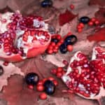 27313633 – ripe pomegranate, grapes and maple leaves