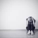22277186 – girl sits in a depression on the floor near the wall monochrome