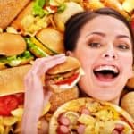 17698317 – thin woman holding hamburger.